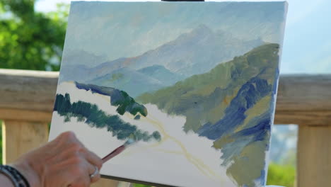 artist painting a mountain landscape