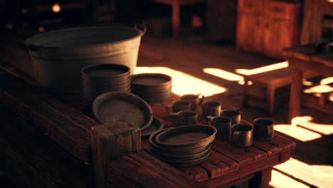 rustic pottery and utensils displayed in a warm wooden setting