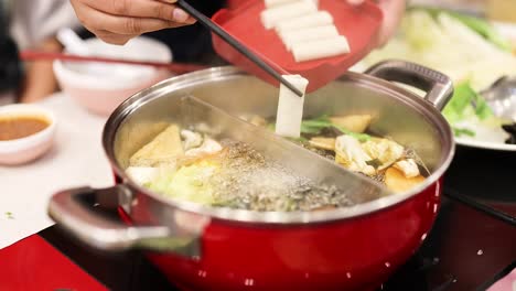 preparing hotpot with fresh ingredients in bangkok