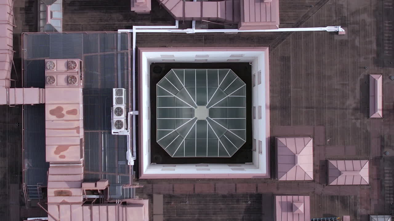Aerial View of a Building's Rooftop with Glass Skylight and HVAC Equipment