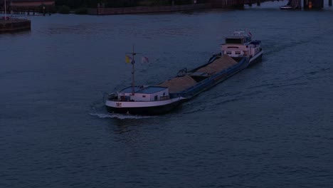 noord vessel cruising through dark blue sea at dawn - cinematic tracking shot