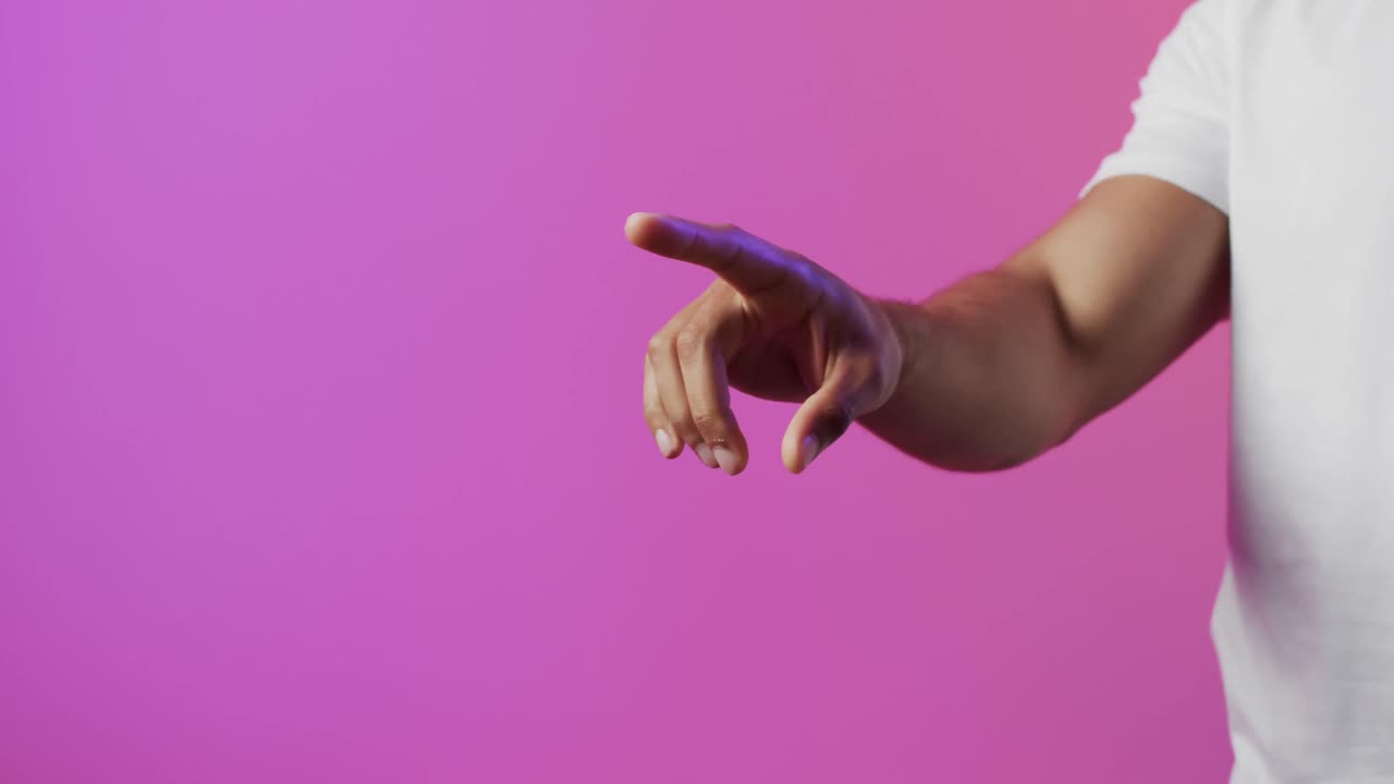 video de un hombre biracial señalando con el dedo usando una pantalla holográfica, con espacio de copia rosa