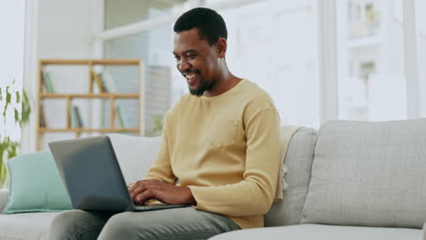 Typing, laptop and black man on sofa working