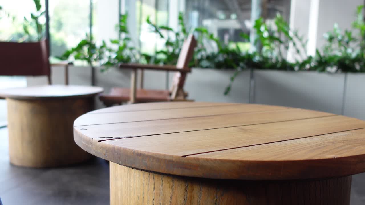 Brown Leather Bag on Wooden Table in a Cafe