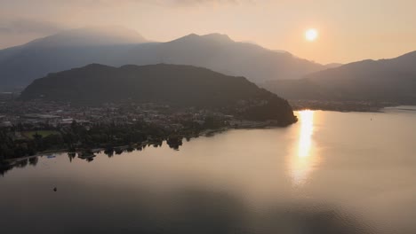 serene landscape scenery of sunrise above garda lake and riva del garda, italy