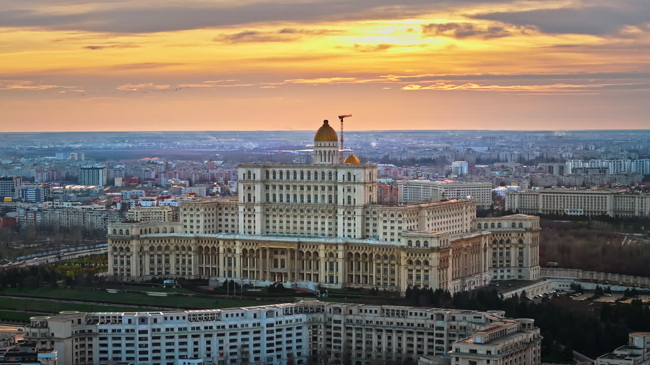 Aerial drone view of Palace of the Parliament in Bucharest downtown at sunset. Multiple districts around, Romania