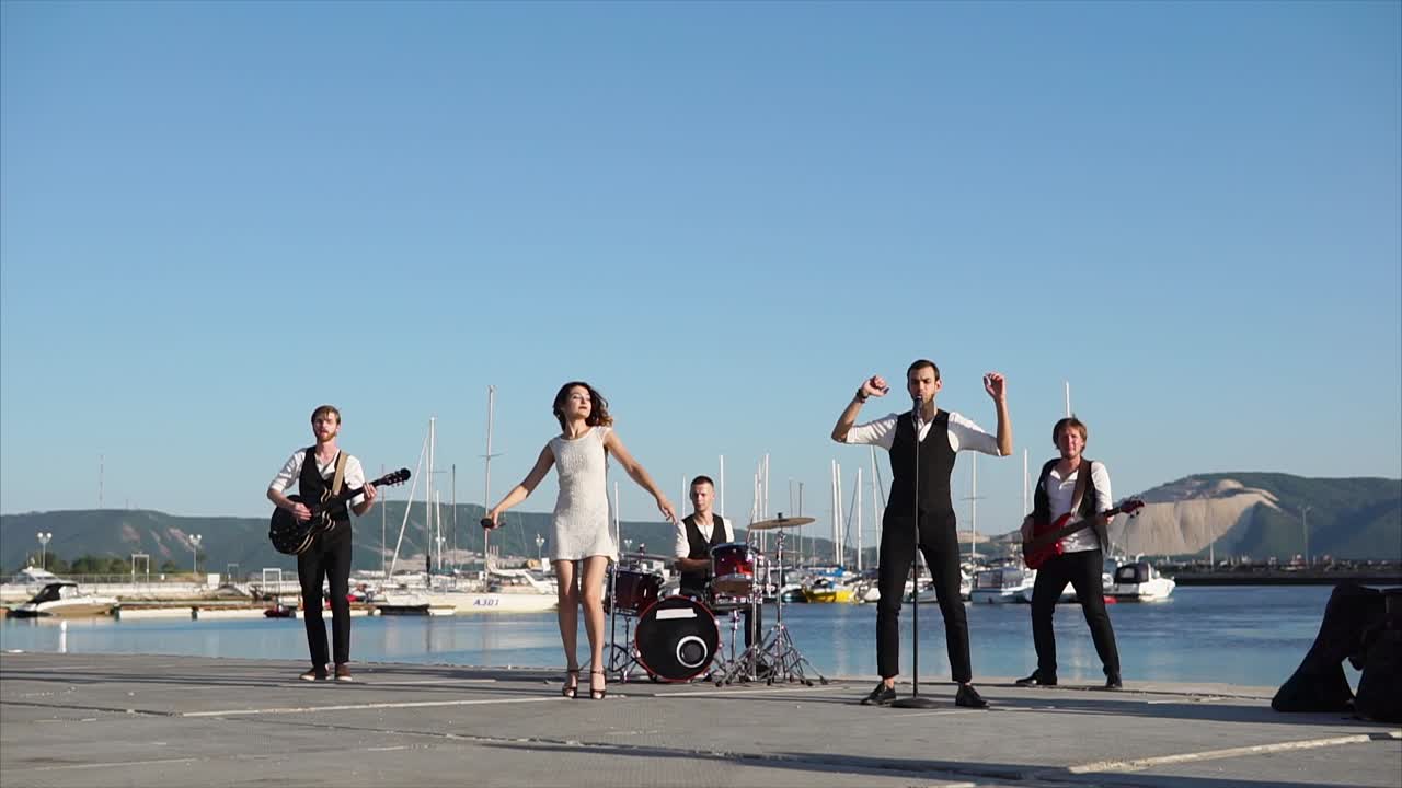 Band Performing Live at a Waterfront Location