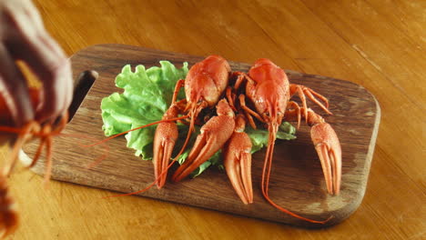 crayfish on a wooden board with lettuce