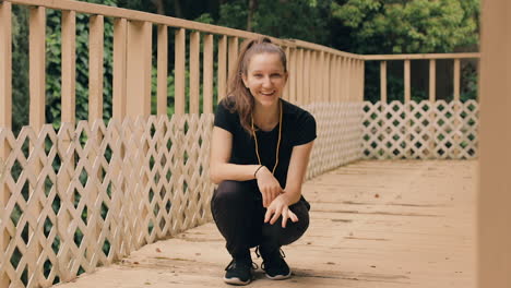 happy caucasian girl dusts off hands, responds to camera, smiles and laughs playfully