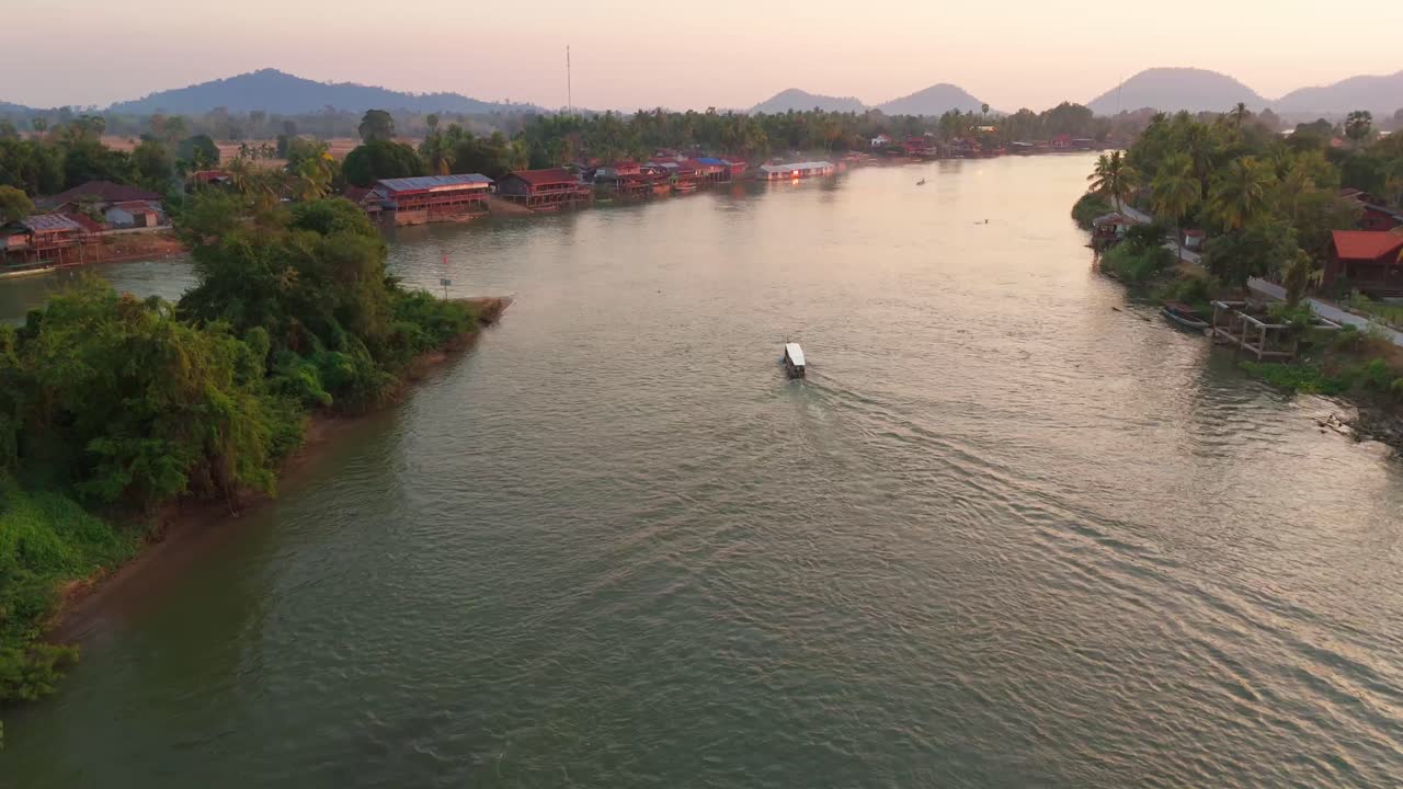 Aerial tracks boat sailing at Four Thousand Islands Laos, traditional village landscape