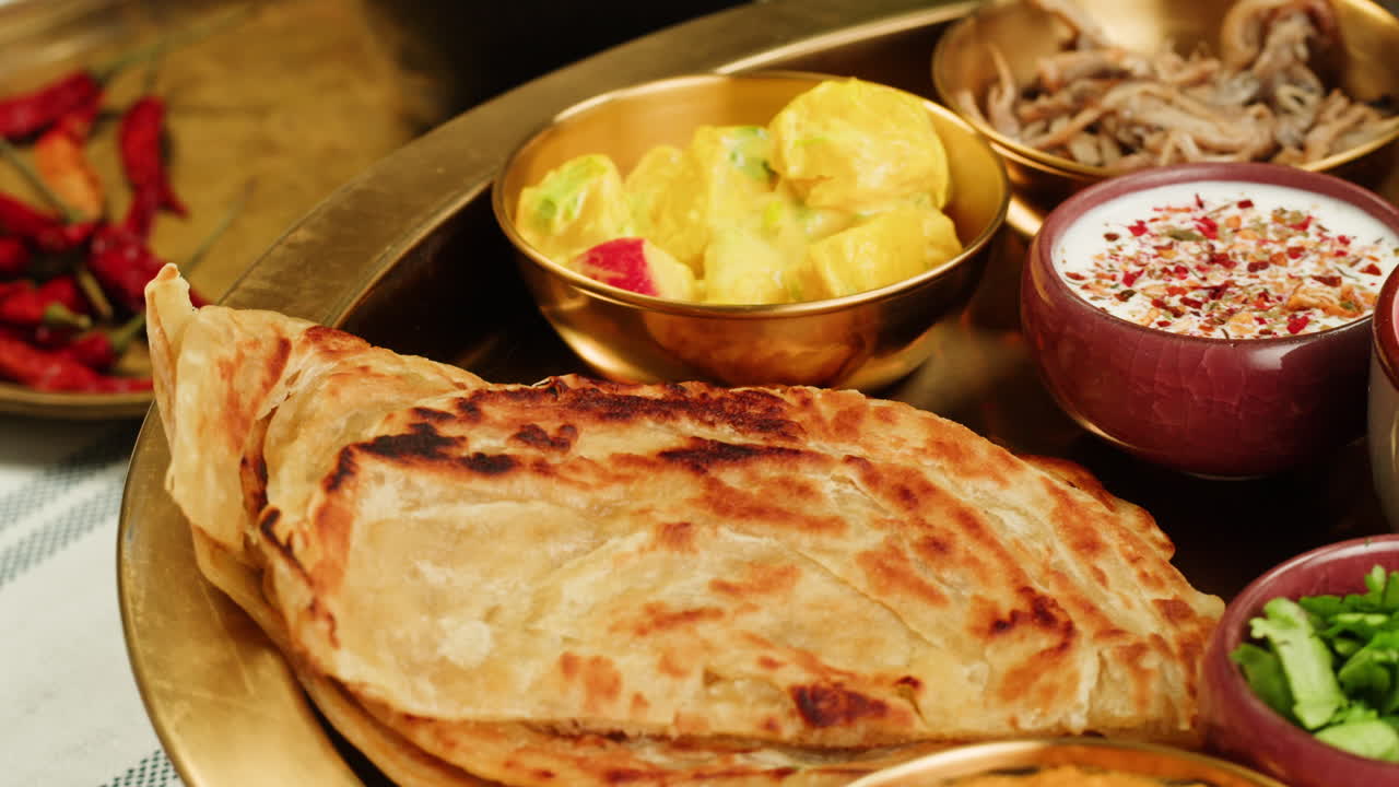 Close-up view of a delicious spicy curry served in a colorful bowl with a spoon, ready for a tasty meal.