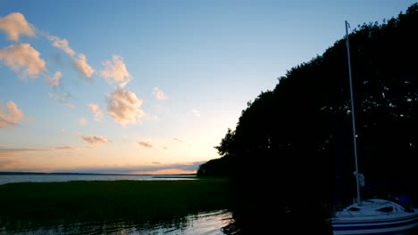 Ein-Nach-Oben-Geneigter-Schuss-Von-Segelschiffyachten-Mit-Weißen-Segeln-Auf-Offener-See-Bei-Sonnenuntergang-Mit-Gelbem-Bewölktem-Himmelshintergrund