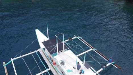 Aerial-over-banka-boat-reveals-tropical-island-scene-and-kayaking-tourists