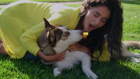 girl playing with a husky dog in the park