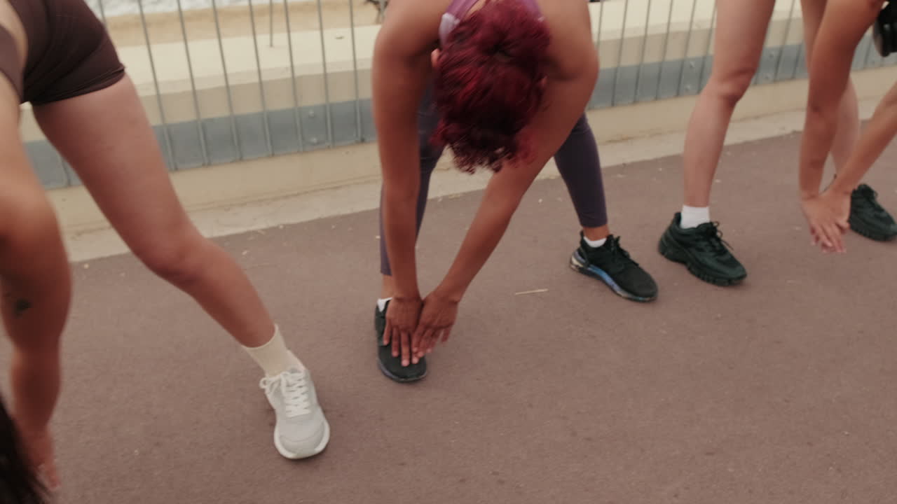 Women Stretching Before Beach Workout