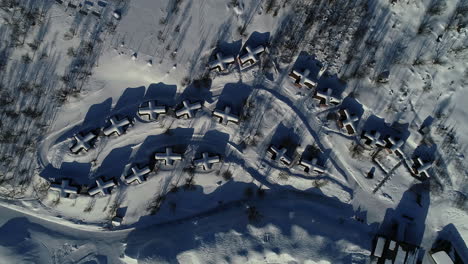 Snow-covered-rooftops-with-cross-shape-huts-in-Snowhotel-Kirkenes,-Norway