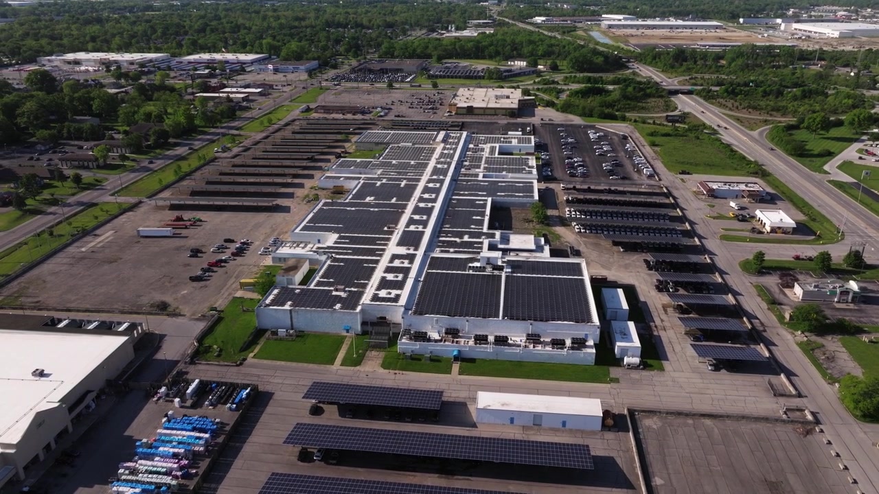 Wide aerial orbit establishing of solar powered data center campus, drone backdrop