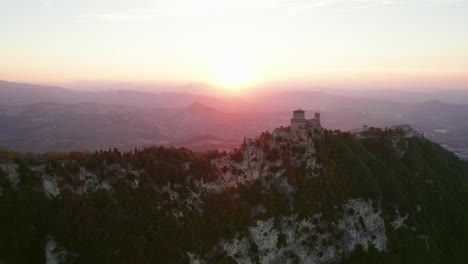 three towers of san marino, italy, drone orbit view during sunset