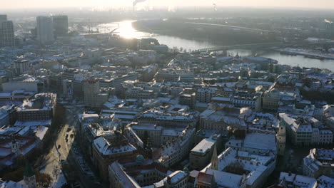 Wide-aerial-shot-of-Bratislava-Old-town-on-sunny-winter-morning,-rooftops-covered-in-snow