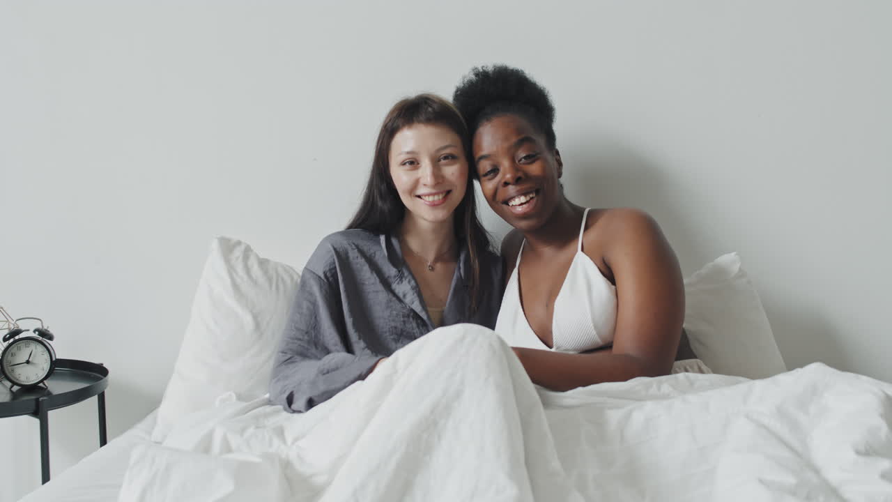 Portrait of Happy Lesbian Couple in Bed