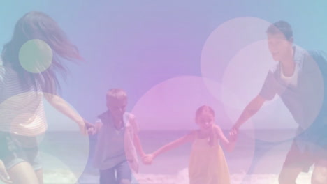 Moving-spots-of-coloured-light-with-family-on-beach