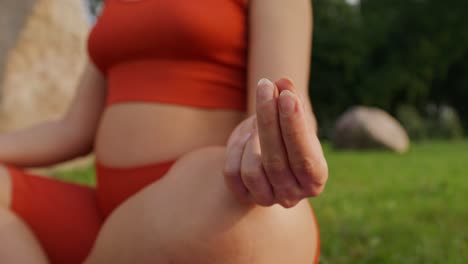 pregnant woman meditating outdoors