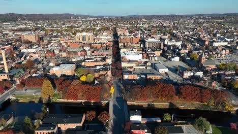 high aerial truck shot of small american city in autumn