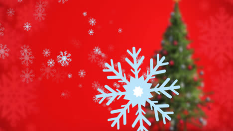 animation of snow falling over christmas tree on red background