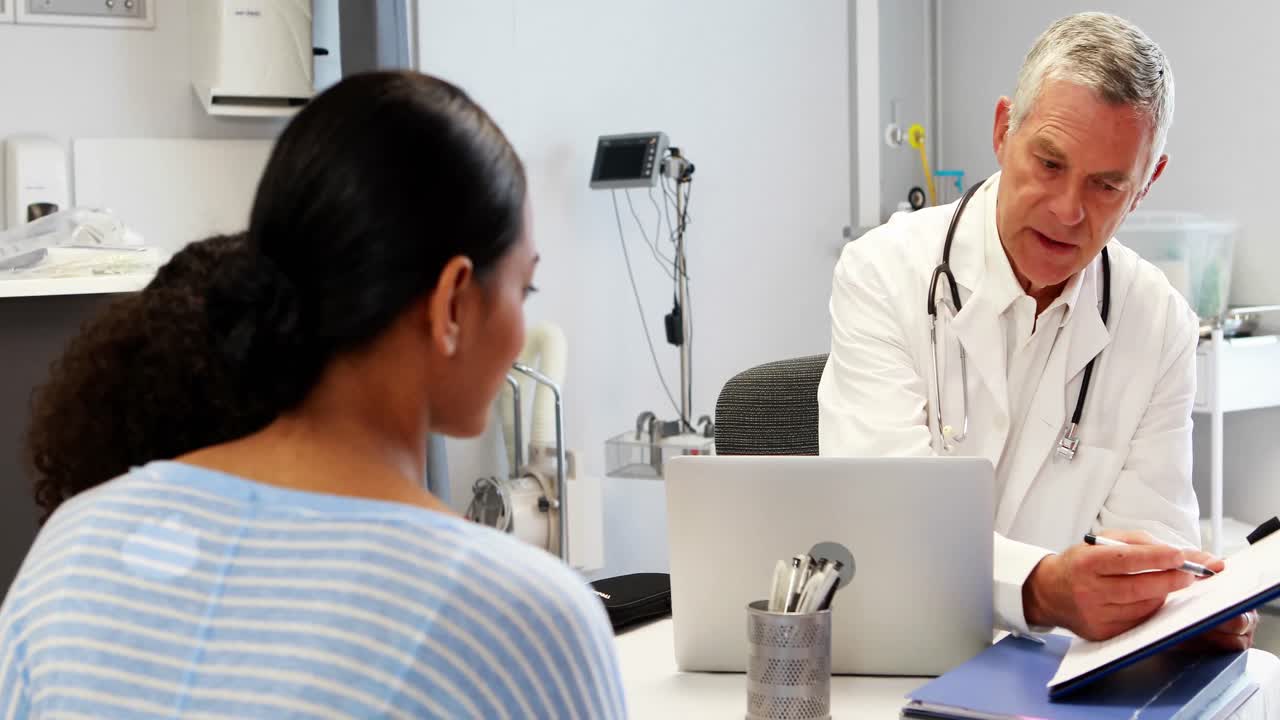 Doctor and patient discussing over medical report