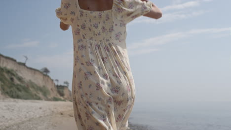 Girl-running-wet-shore-in-slow-motion-back-view.-Woman-jogging-on-summer-waves.