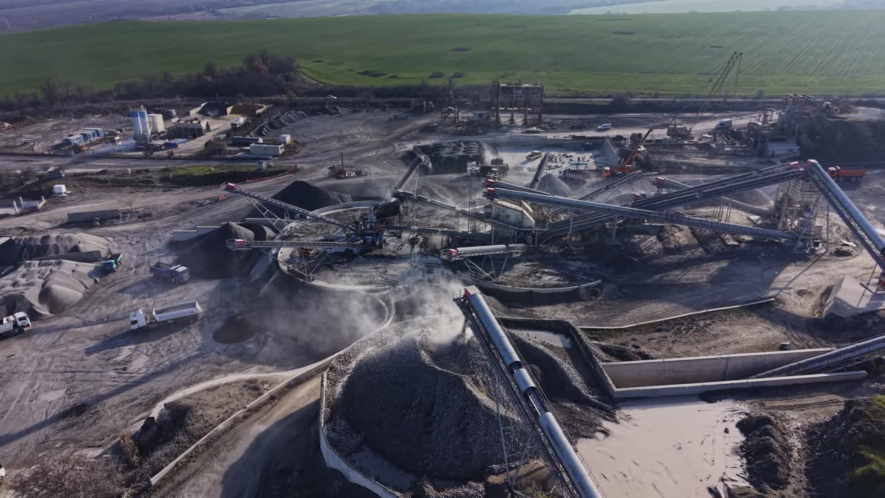 Activity in a quarry with machinery and transport vehicles working together