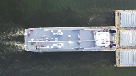 towboat pushing a barge on a river