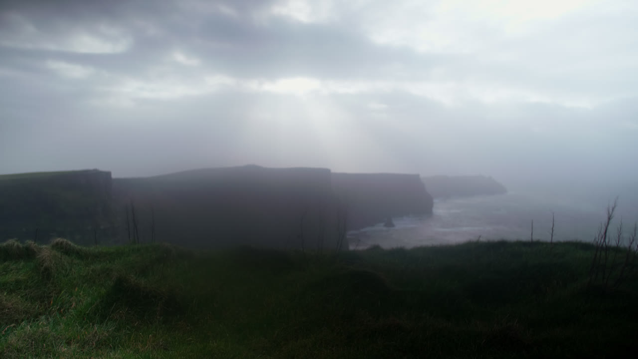 Dramatic Coastal Cliffs Obscured by Fog and Mist