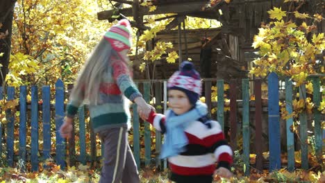 brother and sister playing in the countryside in autumn