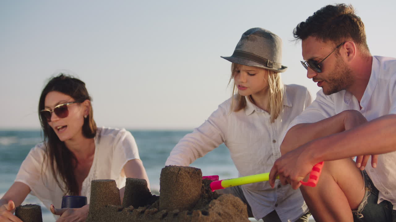 familia construyendo castillos de arena en la playa