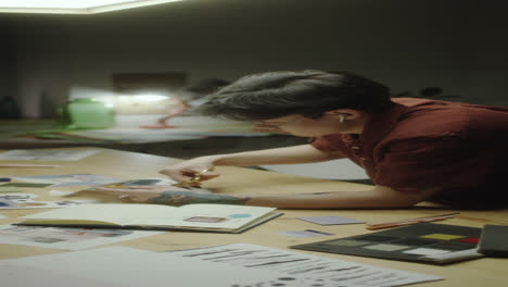 person cutting materials at a creative workstation