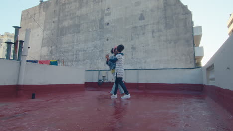 attractive couple dancing tango on city roof