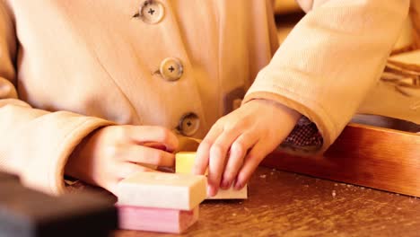 person wrapping soap bars in brown paper