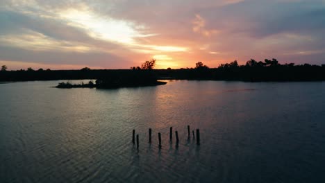 texas sunset aerial drone flyover fishing lake and sunken dock on private hunting ranch in 4k