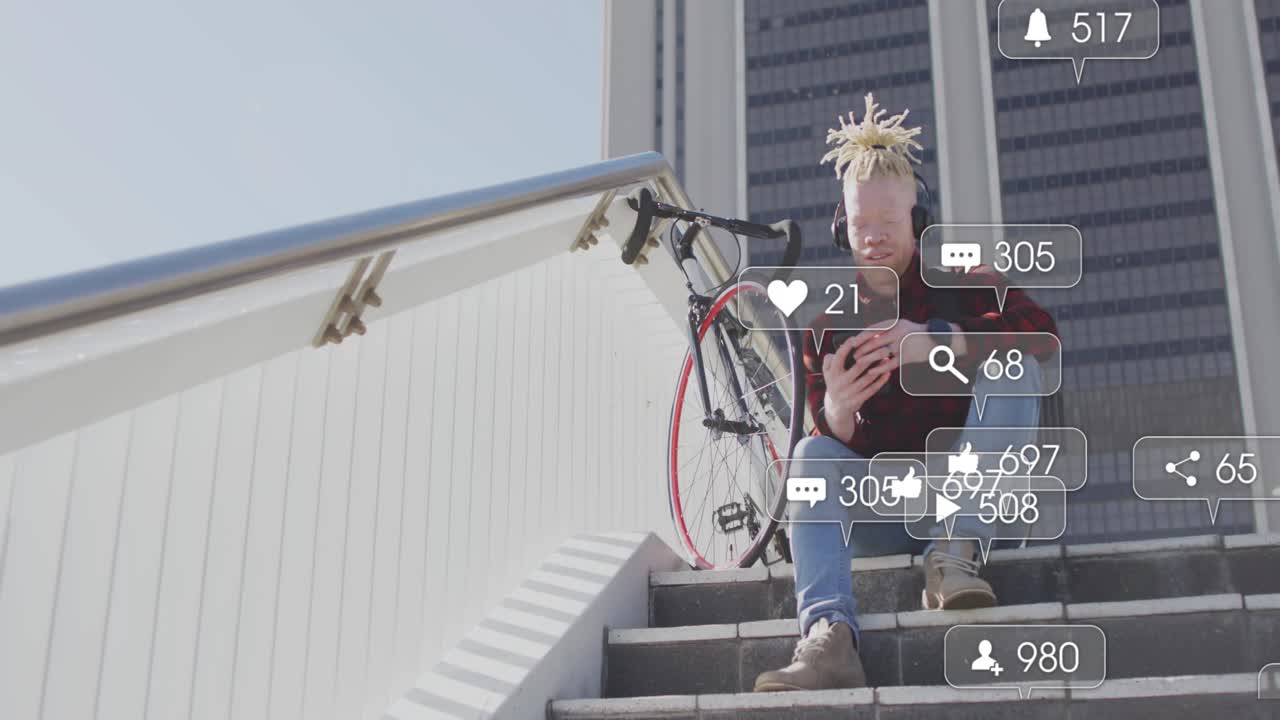 Man on stairs checking phone sparking social media icons fluctuating around head showing engagement
