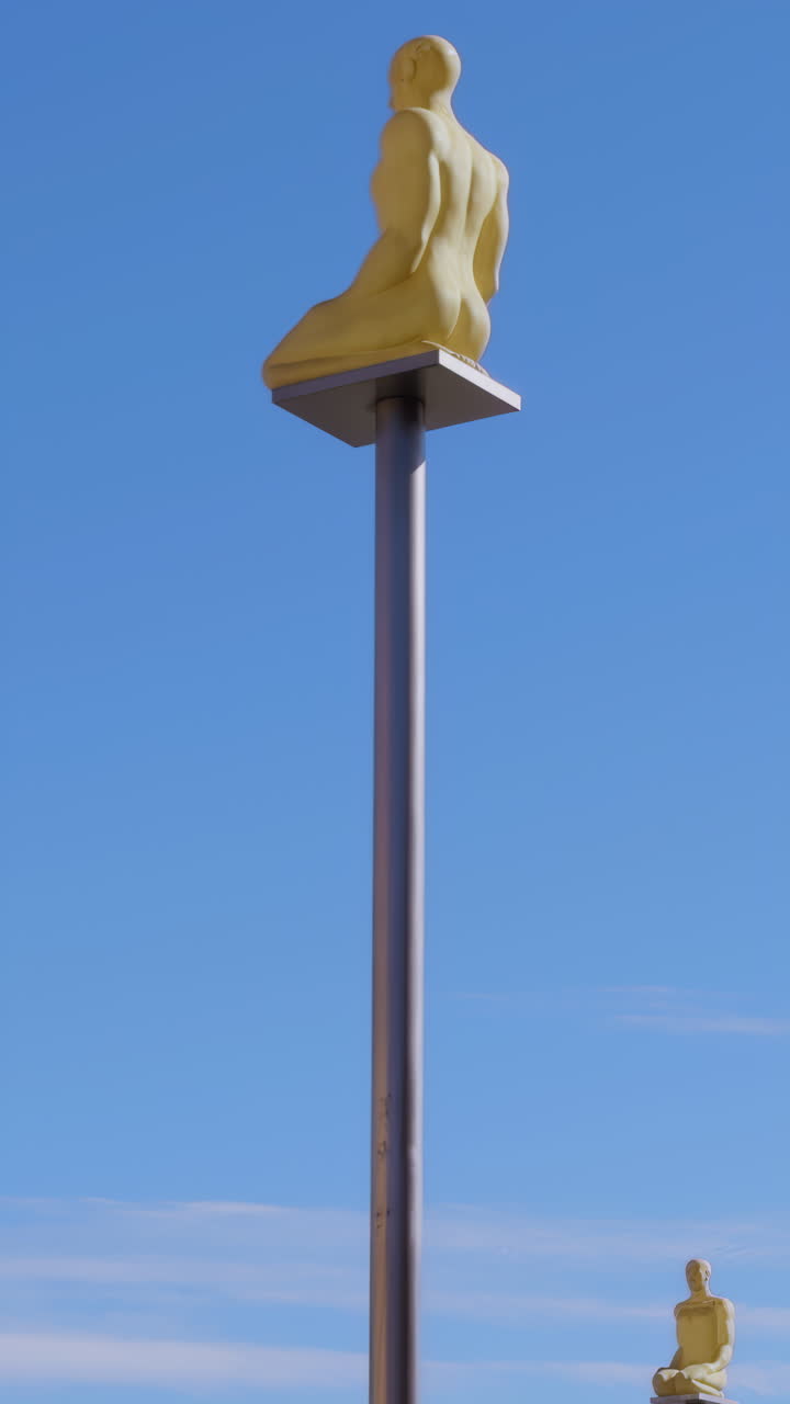 Yellow Sculptures on Metal Poles