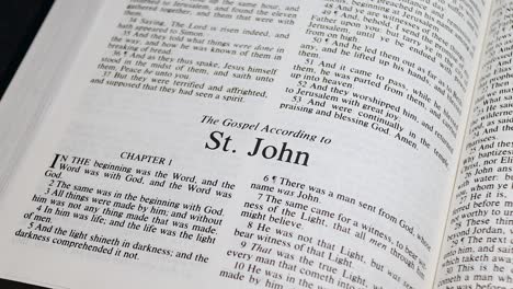 close up shot of bible page turning to the book of john