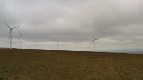 slow spinning wind turbines shot from a drone