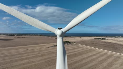 very close orbiting shot of wind turbines spinning