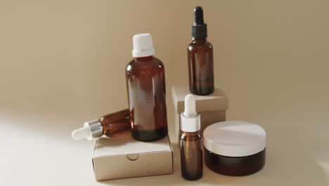 close up of glass bottles and cardboard boxes with copy space on white background