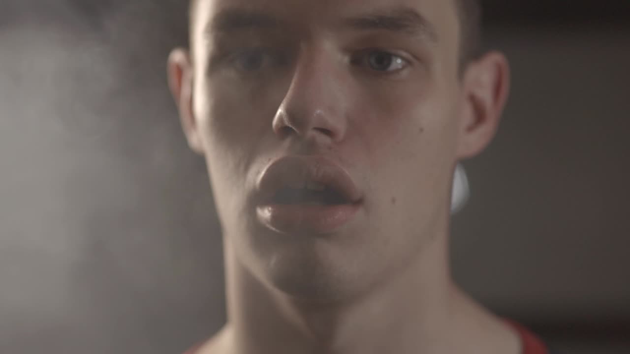 Closeup Of A Young Man Vaping With White Smoky Air Coming From His Mouth - Slow Motion