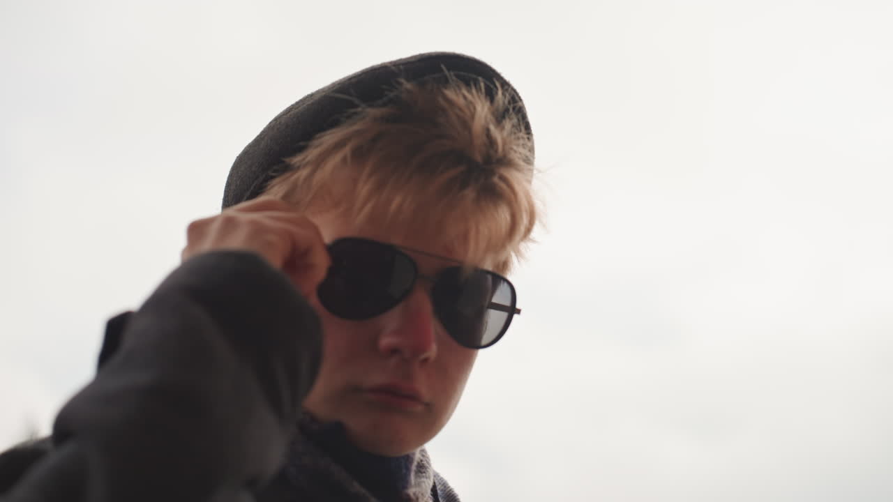 Creator observes harbor skyline mood. Overcast light enhances waterfront creative portrait atmosphere. Cinematic style with overcast lighting portrays creator surveying harbor from behind