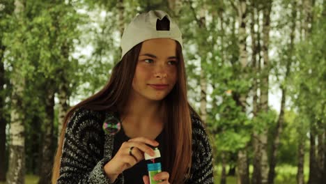 girl blowing bubbles in the nature