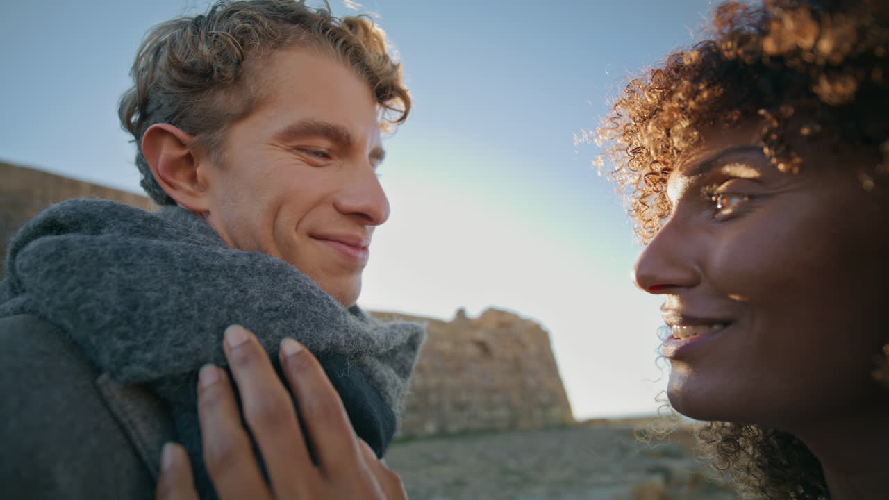 Romantic people face looking together nature closeup. Curly woman caressing man