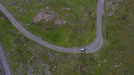 downward angle drone shot of vehicles on bealach na ba applecross road through the mountains of the applecross peninsula, in wester ross in the scottish highlands